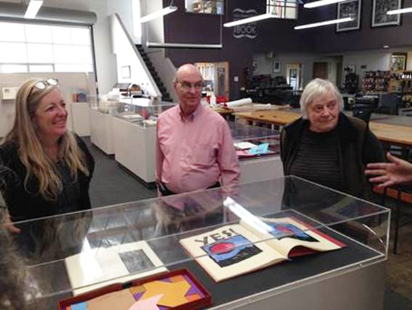 Click the image for a view of: Mary Austin, Jack and Claire Van Vliet at the Center for the Book, SF, with the retrospective exhibition for the Janus Press on display